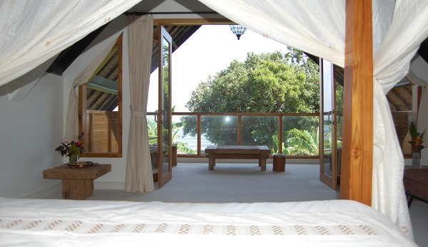 View from Kingsize bed to balcony, trees and sea